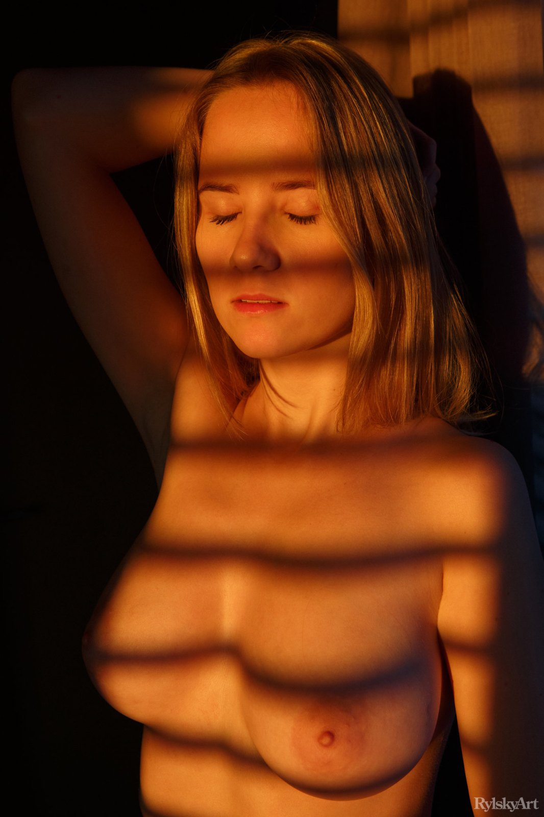 Fabulous blonde Delizi poses naked while shadows cover her perfect body  in Rylsky Art set Domashka