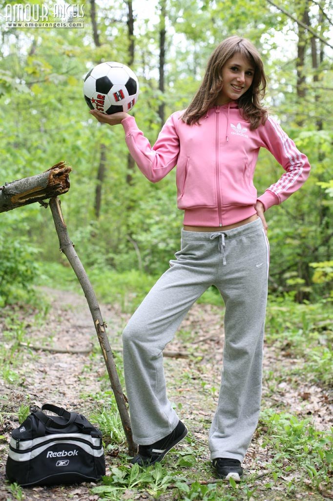 Slender brunette Inna takes off almost everything and poses with a ball in a woods  in Amour Angels set Inna Football