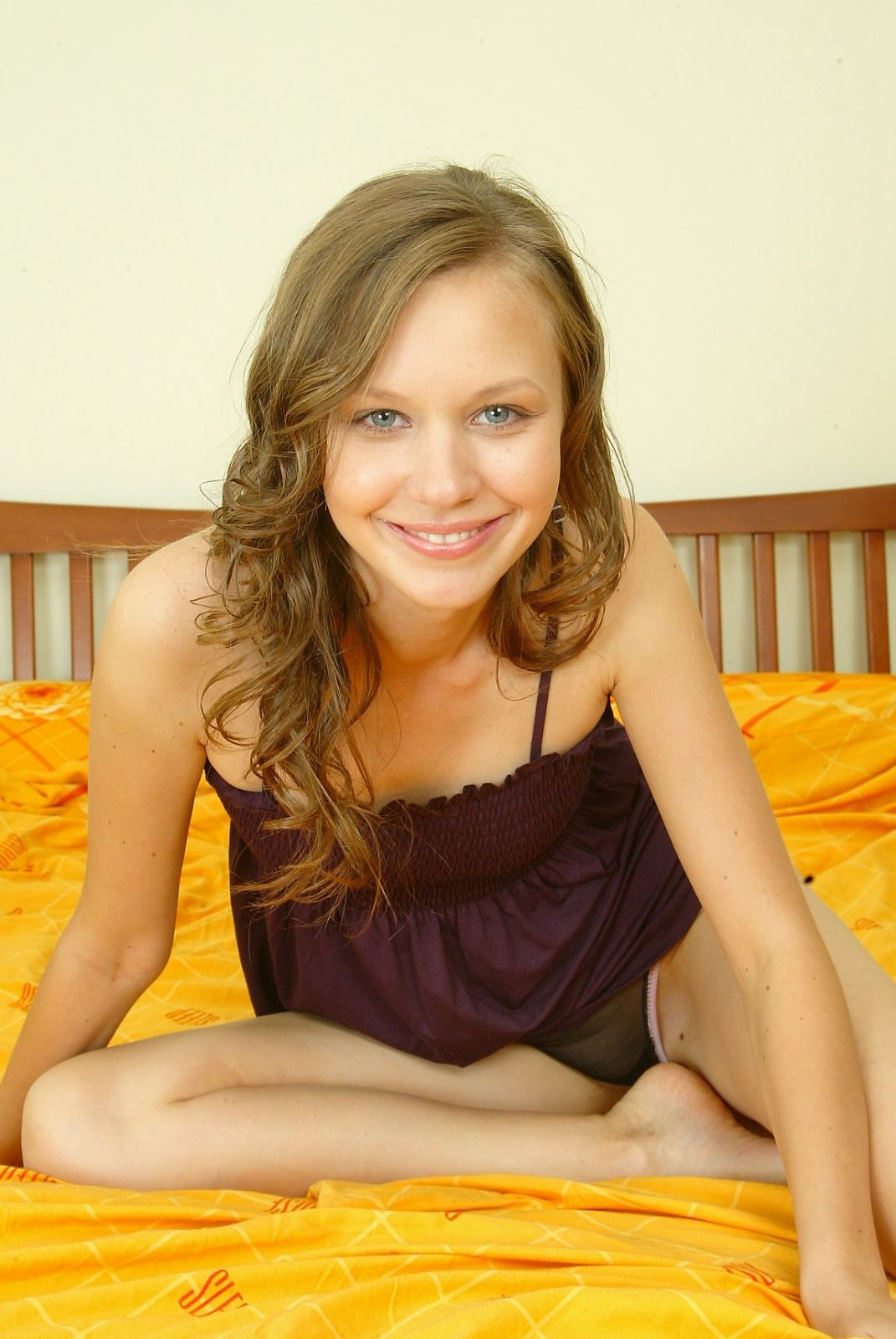 Cute Ukrainian teen poses on her bed