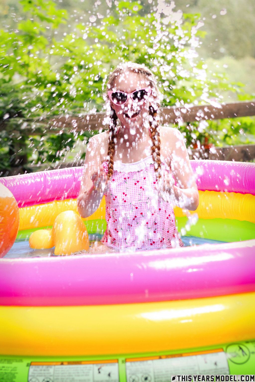 Playful girl Dolly Little is playing naked in the small pool showing off her skinny body  in This Years Model set Little Splash