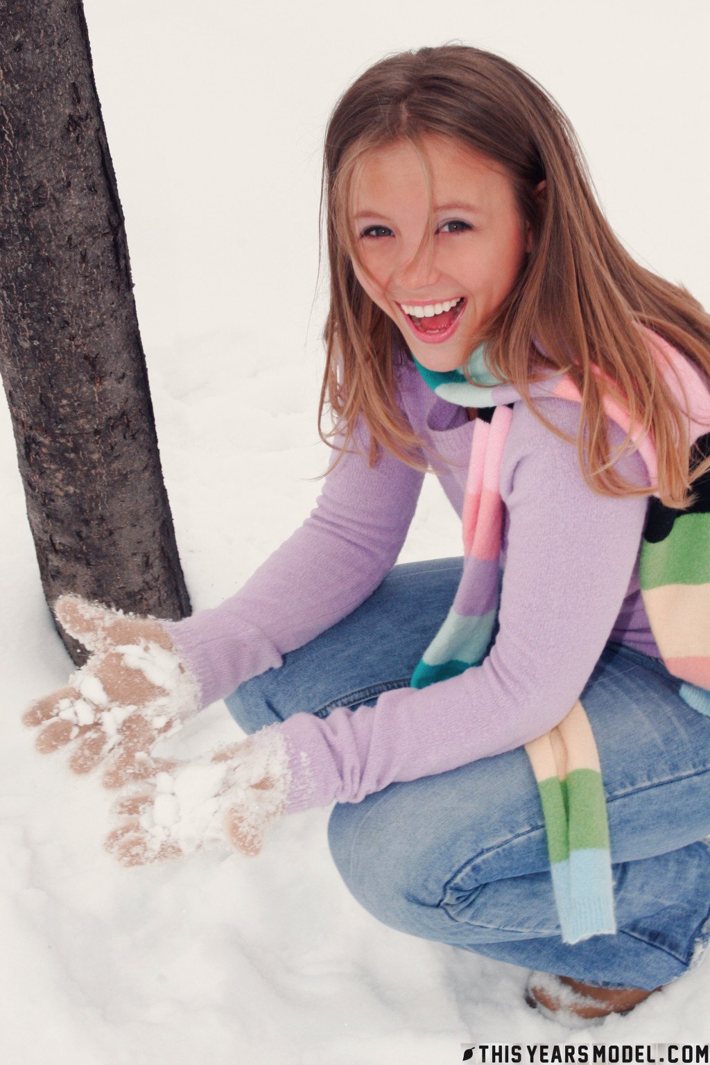 Gorgeous young babe playfully poses on the snow and dazzles us with her smile  in This Years Model set Snow Days