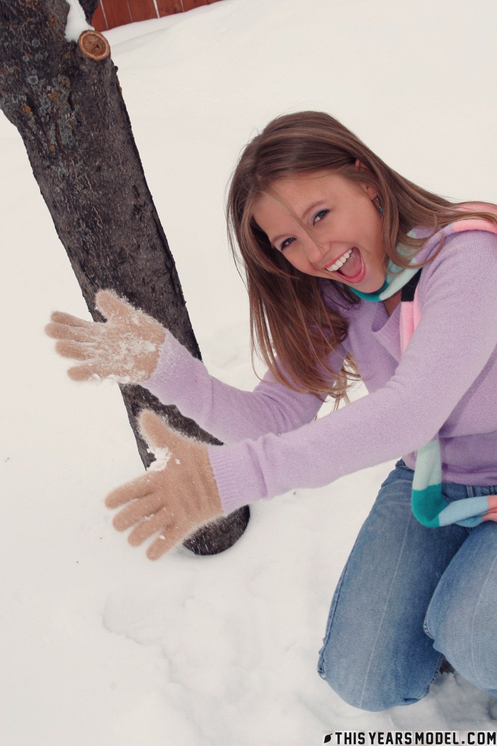 Gorgeous young babe playfully poses on the snow and dazzles us with her smile  in This Years Model set Snow Days