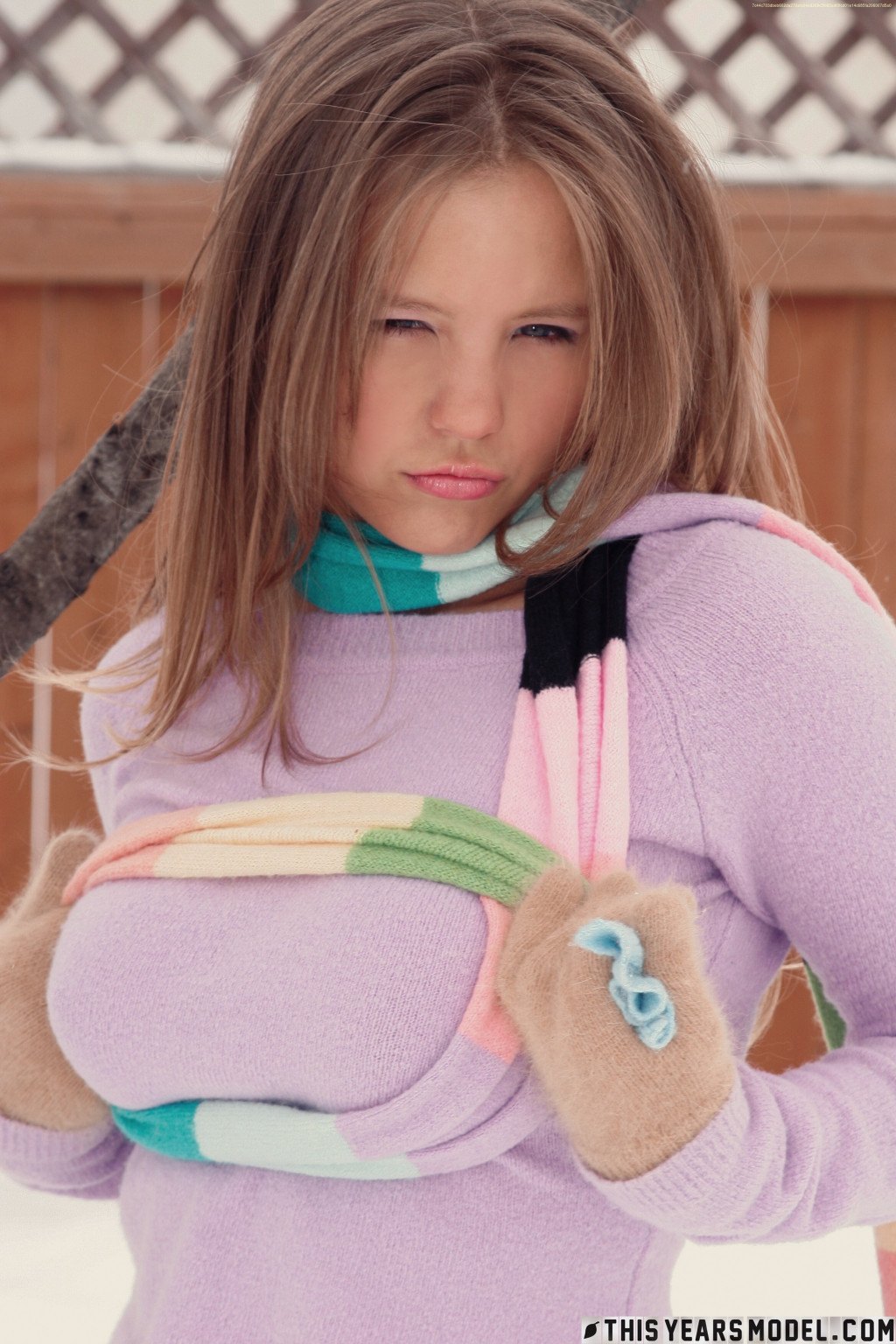 Gorgeous young babe playfully poses on the snow and dazzles us with her smile  in This Years Model set Snow Days