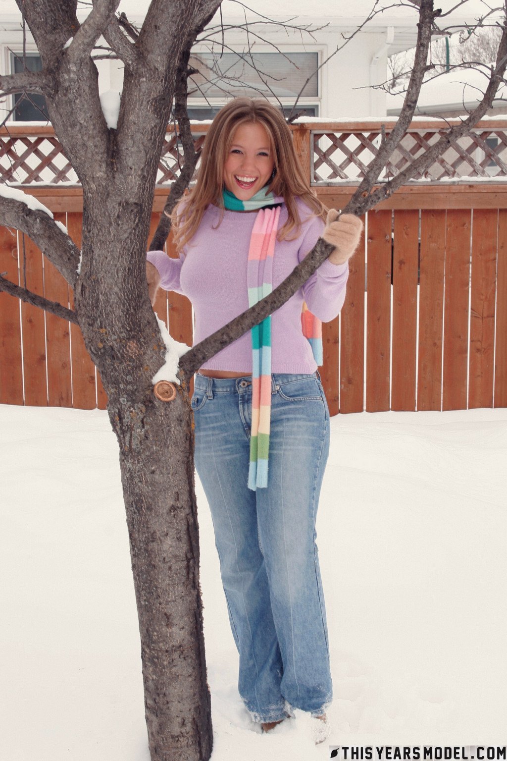 Gorgeous young babe playfully poses on the snow and dazzles us with her smile  in This Years Model set Snow Days