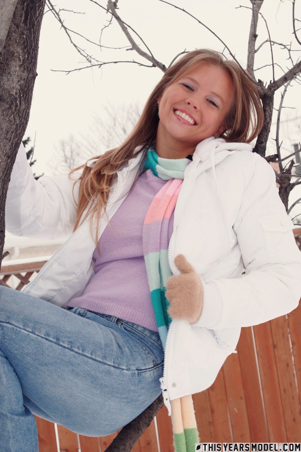 Gorgeous young babe playfully poses on the snow and dazzles us with her smile  in This Years Model set Snow Days