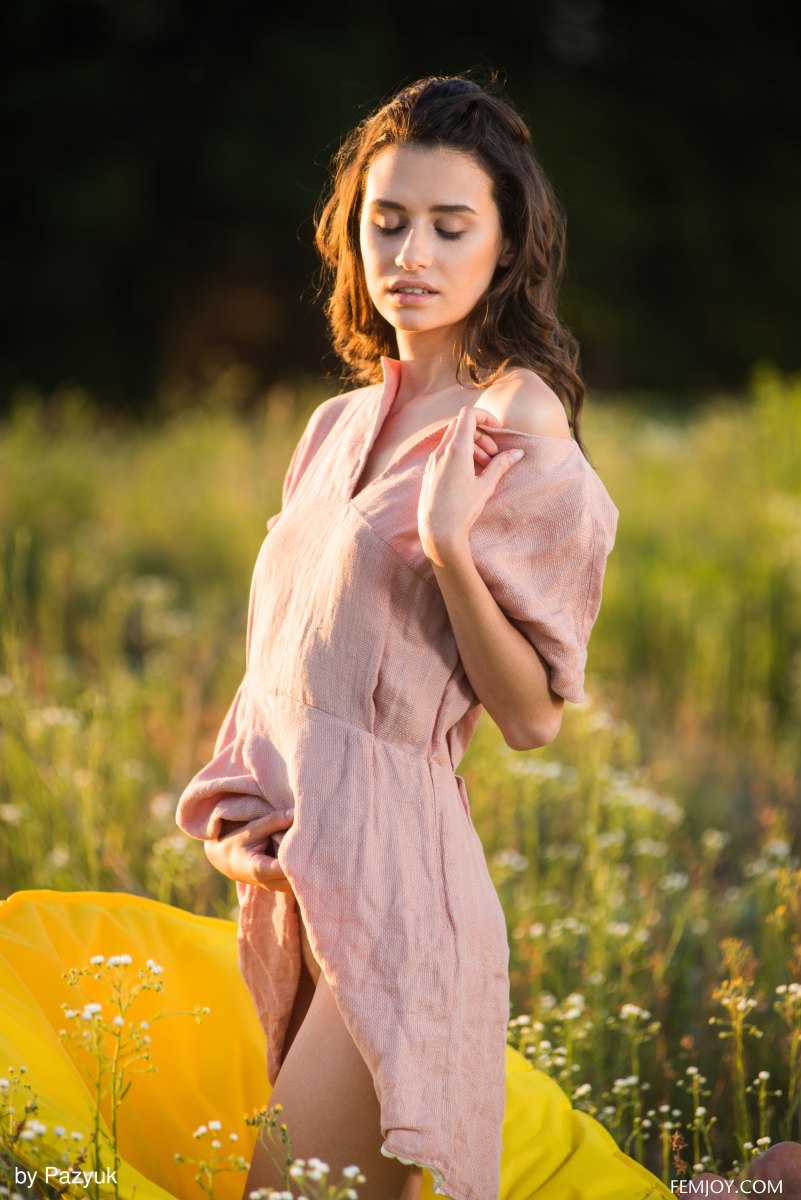 Sweet and charming babe Cristin M shows her assets outdoors in a meadow  in Femjoy set Summer Memories