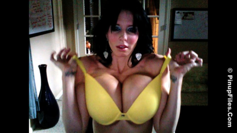 Naughty brunette shows off her big tits at home for your delight