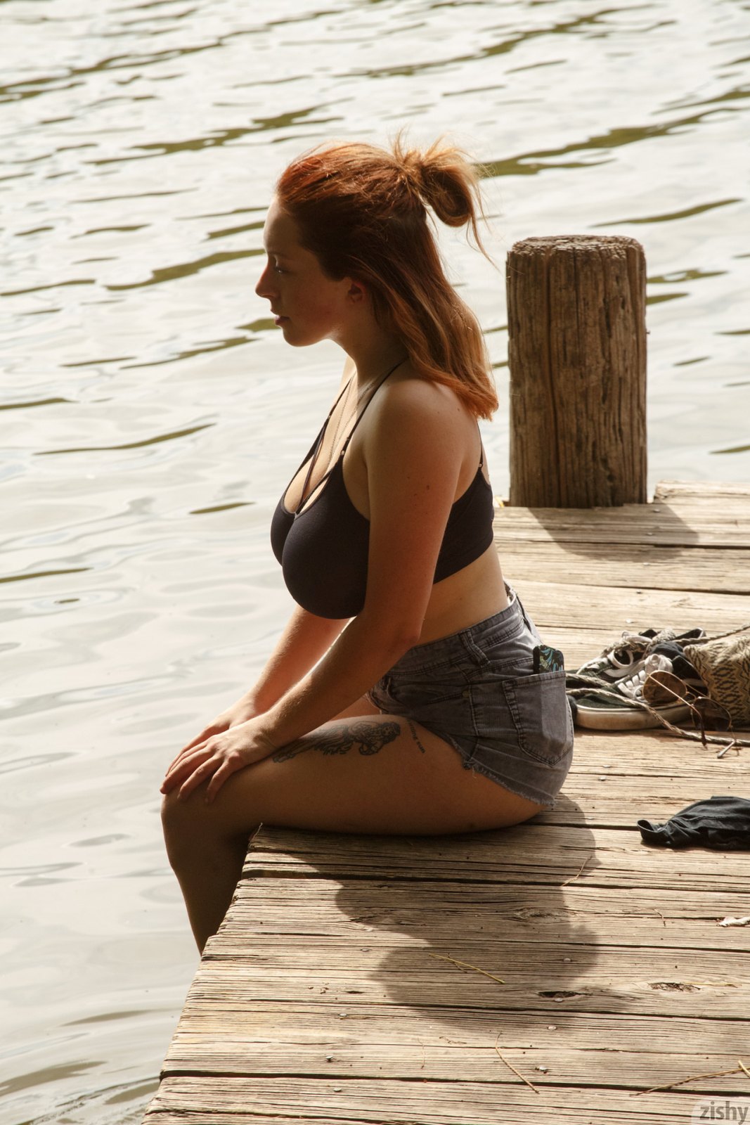 Busty and naughty redhead exposes her huge melons on the river dock  in Zishy set Deep Eddy