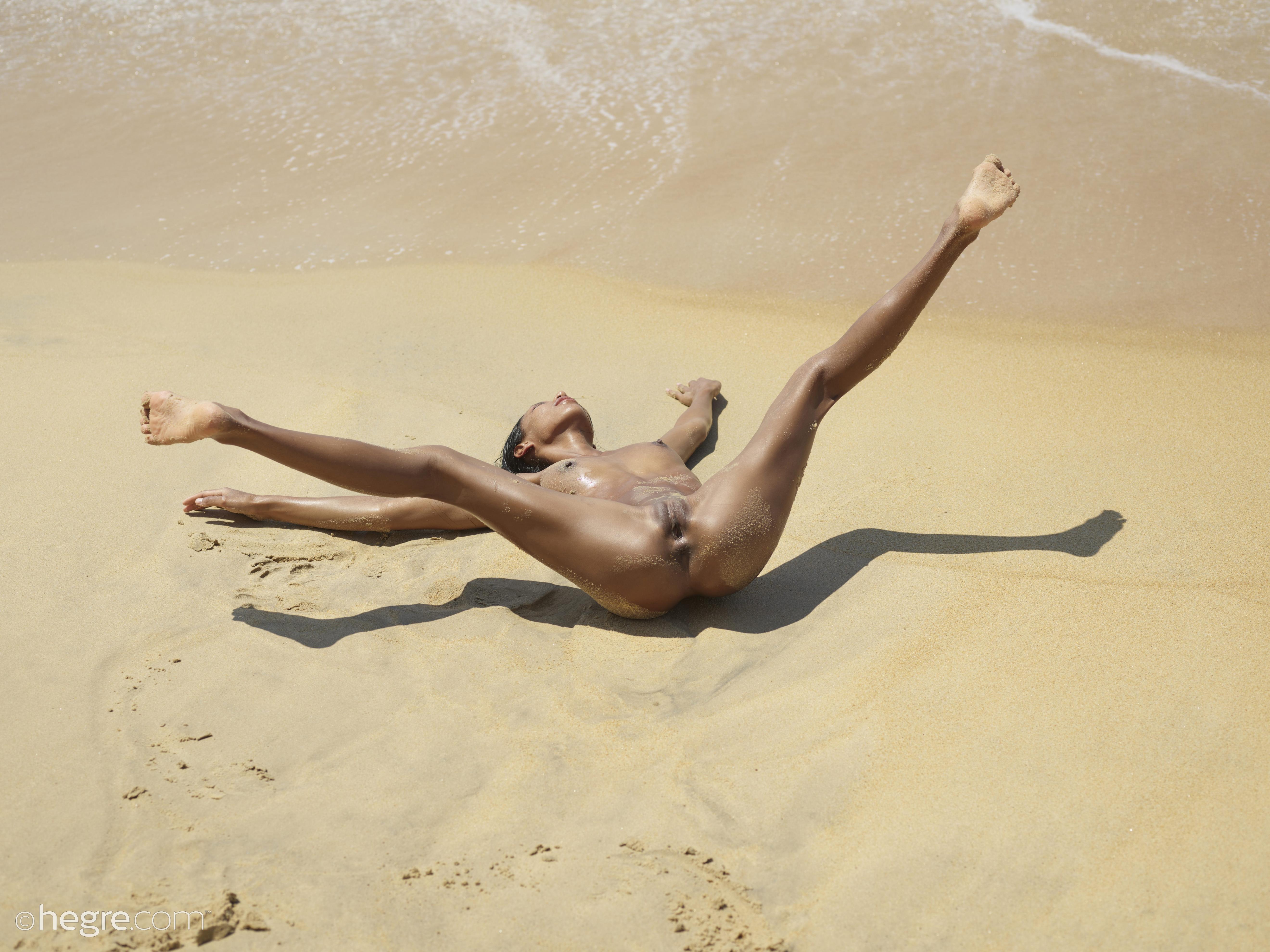 Amazing exotic beauty shows how stretchy she is while posing naked on the beach  in Hegre Art set Naked beach acrobatics