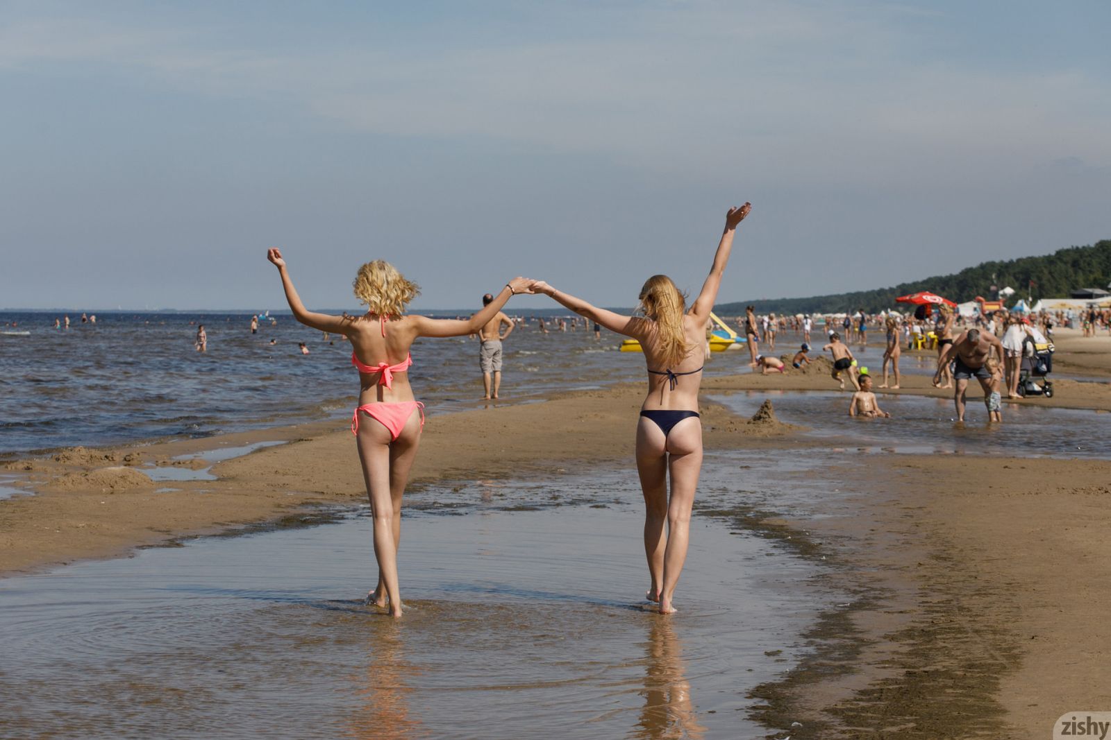 Two hot chicks are showing off their asses in this nice beach posing staff  in Zishy set Sunny Bunnies 2