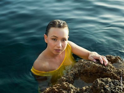 Chick with nice curves Taylor Sands gets wet and naked on the rocks by the sea  in Ultra Films set Claiming The Sea