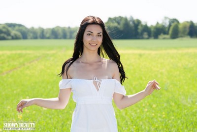 Brunette goddess delightfully poses on the meadow presenting her smooth pale breasts  in Showy Beauty set Meadows 2